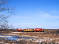 The other Copetown.  The CP Rail operation of the Nanticoke steel train rumbles westbound along the Waterford Subdivision at Copetown, passing the muskeg ponds approaching the Highway 52 crossing near Powerline Road.  Power includes a pair of MLW C424s bracketing the leased Chessie (B&O) GP38 4806.<br><br>Built by MLW in 1965, both C424s would be retired in the late 90s, with 4207 retired in 1996 and sold to Century Metals of Lachine, Quebec for scrap in 1997, and 4227 sold to HELM in 1997 for refurbishment and future sale to the Apache Railway.  It was still in operation <a href=http://www.rrpicturearchives.net/showPicture.aspx?id=5358069>as recently as 2018</a> as their 98.  B&O 4806, built 1970, has had a number of owners and numbers, starting with <a href=http://www.rrpicturearchives.net/showPicture.aspx?id=131902>CSXT 2106,</a> to Grand Rapids and Eastern Railroad 5106, <a href=http://www.rrpicturearchives.net/showPicture.aspx?id=2772319>renumbered to GR 3839,</a> and now operating for the G&W family on the Mid-Michigan Railroad <a href=http://www.rrpicturearchives.net/showPicture.aspx?id=5381927>as the 2057.</a><br>,<br>A few days before on March 27, Robert Farkas <a href=http://www.railpictures.ca/?attachment_id=33426>snapped this power</a> at Chatham Street roundhouse, and it appears Doug Page <a href=http://www.railpictures.ca/?attachment_id=31712>also shot the run above</a> over at Aberdeen Yard before departure.<br><br><i>Dave Stowe Photo, Jacob Patterson Collection Slide.</i>