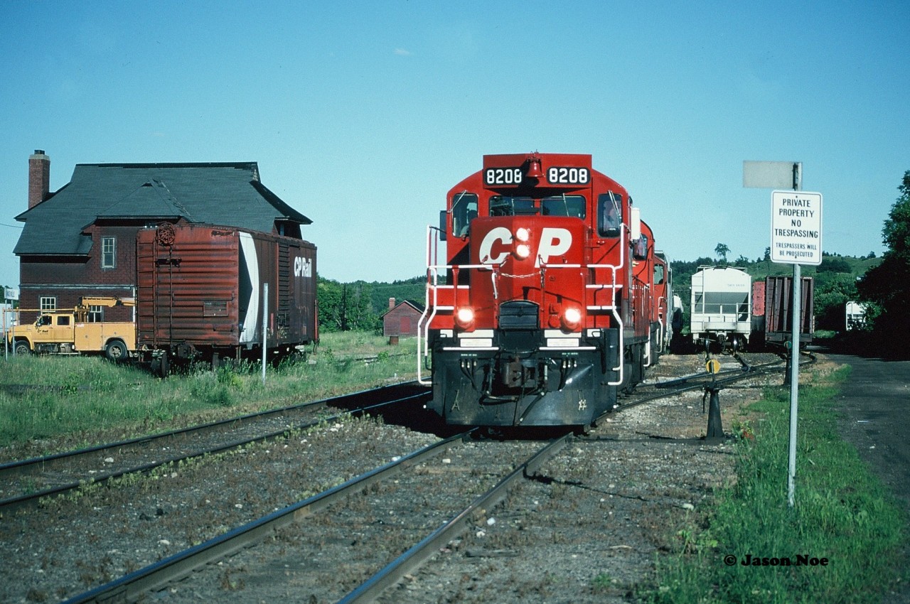 The CP Moonlight with 8208, 1117 and 8243 is viewed switching the yard in Orangeville during a summer evening. Once they are done sorting the cars, the engineer asked us if we wanted a cab ride to the other end of town where they were taking two hoppers to an industry at Mile 36. It was an easy decision, so we quickly boarded GP9u 8208 and then headed north through Orangeville.