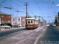 TTC Peter Witt streetcar 2766 is operating on a fantrip <a href=http://www.railpictures.ca/?attachment_id=43648><b>around the city</b></a> today, seen here heading southbound on Weston Road at Northland Avenue after looping at Avon Loop at the north end. The sign for the art deco-ish Lyons Furniture store (now a self-storage place) is visible on the right. While most of the Witt fleet fell out of use when the University Subway line opened in February 1963, a few cars like 2766 were kept around for occasional use and fantrips. As of January 1965 there were 13 cars left on the property, but most were sold for scrap early that year. July was the final month of Peter Witt operation before the final active car, 2766, was retired (but was kept, and later overhauled and brought back in <a href=http://www.railpictures.ca/?attachment_id=46184><b>Tour Tram service</b></a> in 1973).<br><br>This stretch of streetcar track on Weston Road was once home to the old Weston Road streetcar service (from West Toronto to the town of Weston), but by this time the remaining section from St. Clair to Avon Loop (at Rogers Road) only saw some rush hour St. Clair streetcars. The final cars ran on February 25th 1966, the day before the new Bloor-Danforth subway opened and streetcar network revisons came into effect (St. Clair cars then ended their runs at <a href=http://www.railpictures.ca/?attachment_id=46753><b>Keele Loop</b></a>, and the tracks up Weston were abandoned).<br><br><i>John F. Bromley photo, Dan Dell'Unto collection print.<i>