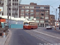 TTC PCC 4341 (A6-class, built by CC&F in 1947/48) operating on the Dundas route bound for <a href=http://www.railpictures.ca/?attachment_id=36016><b>Runnymede Loop</b></a>, heads westbound on Dundas at Victoria through the street's jog between Bond Street and Yonge Street, nearing the stop at Yonge (a major interchange point, as it connected with the Yonge subway line - note stairwell at left). Under demolition in the background by Greenspoon is the old O'Keefe's Brewery, that nearby Ryerson University purchased in 1966. It was demolished and replaced with a parking lot, that became a parking garage and student bookstore, that had the commercial/retail development 10 Dundas East built on top of it (in exchange for Ryerson using some of the AMC theatres as lecture halls). Most of the old buildings in the background along the east side of Victoria remain in one form or another today, and to the right out of frame is the original <a href=http://www.railpictures.ca/?attachment_id=39305><b>"Dundas Square"</b></a> block of retail buildings. <br><br> Notable mentions to to the Canada Centennial 1867-1967 markings on the metal trash bin, the green Daily Star box, what appears to be a Mercury Monterey, and the northbound only markings for this Dundas station entrance (one had to enter the stairwells on the east side of Yonge Street for northbound trains, and the west side one for southbound trains - a station oddity in the system that existed for decades before being fixed more recently). <br><br> <i>Original photographer unknown, Dan Dell'Unto collection slide.</i>