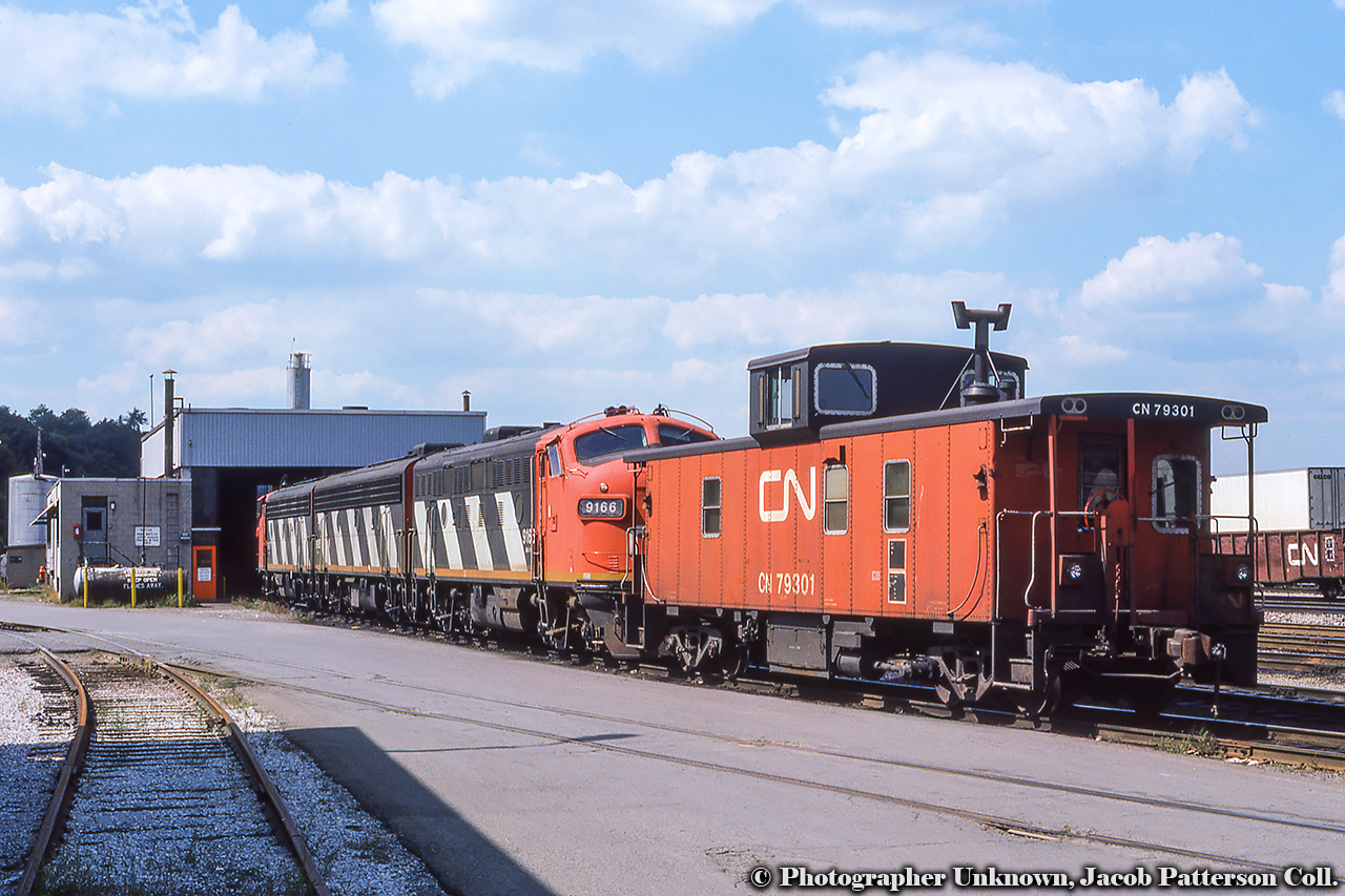 Power for train 725, the Nanticoke Steel train, sits at the Hamilton diesel shop with Hawker Siddeley van 79301, one of 150 built in 1967 in the 79200 - 79349 series.

Original Photographer Unknown, Jacob Patterson Collection Slide.
