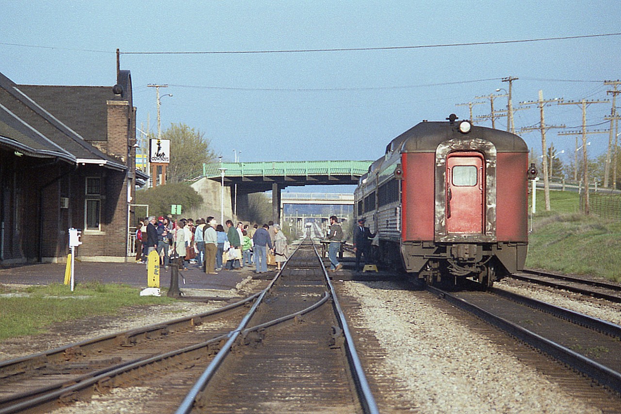 When you look at a scene like this you have to wonder how VIA (and the government) managed to kill the country's passenger business.  In this image, people have de-trained the Niagara-bound Budds while the Amtrak #98 slows in the distance until all is clear before making its' station stop.
In 2021, Amtrak is canceled due to covid; the two each way Budds gave way to VIA trainsets; in 1990 that got chopped....VIA service reinstated; then chopped...........the scene is repeated all over the country. When I lived in St. Catharines, my sidekick back in the day enjoyed visiting her parents up in Unionville by taking the train.......it was easy. Now? Good luck trying THAT !!! It is a lonely place around St. Catharines station these days.