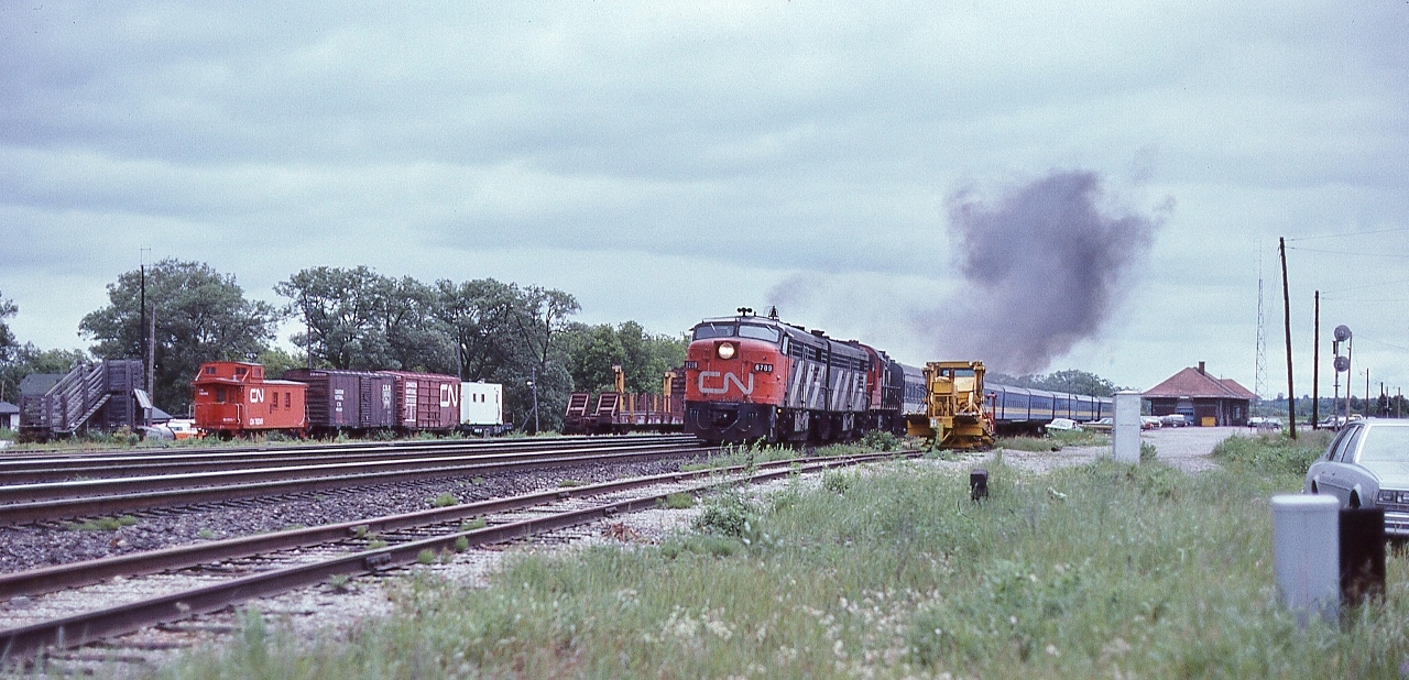 MLW's rule ! 


    VIA CN FPA-4  #6789, VIA CN FPB-4 #6865 and CN RS-18 #3105  have the morning Capital / Lakeshore, trains 43 / 53, on the move, 


    Accelerating from the Cobourg station stop, June 23 1979 Kodachrome by S.Danko


    interesting:
 

    at left note the livestock loading pen and ramp, CN work train caboose and rail transport work car, 


    and the main line ribbon rail looks relatively new, 


    at extreme right is my '77 Impala, and above the Impala is the CP Rail westbound searchlight home signal for the CN  Cobourg Town Spur (CTS) interlocking at CP Rail Belleville Subdivision mile 135.2:

		
    CTS: Switch points face west from CN track KS12 (south service), interlocking controlled by the CP Rail Train Dispatcher.


    CTS: Originally the Cobourg Railway Company incorporated 1834, commenced operation 1853 ( three years prior to the GTR ( now the CN Kingston Sub.) completion)  as the Cobourg & Peterborough Railway (C&P). The 2 mile causeway and bridge over Rice Lake was problematic and by 1866 the railway was re-routed east of the Lake and renamed the Cobourg Peterborough and Marmora Railway (CPM) 


    The industrial tracks on the north side of the Kingston Subdivision were known as the Cobourg Yard, now known as Cobourg.
   

    sdfourty