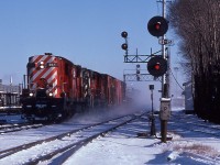 <br>
<br>
   Westbound at the CP Rail Leaside crossover *
<br>
<br>
  The one and only: The Empress, MLW 1957 built RSD-17, CP Rail #8921 ( assisted by RS-18 #8795 ) in charge of  The Transfer. 
<br>
<br>
    track on the right is the Don Branch mile 206.4 Belleville Sub., track switch at near left is for the south service track, to right in the distance is the VIA kiosk for the Havelock Budd 
<br>
<br>
   at CP Rail mile 0.2  North Toronto Subdivision, Kodachrome,  December 22, 1979  by S.Danko
<br>
<br>
   notable:  *   Crossover, single: for many decades, just one at Leaside  from south track to north track, to allow eastbound Don Branch traffic ( used by the Havelock Budds) to access the north track, hence only the double absolute signal required for eastbound north track traffic. 
<br>
<br>
  sdfourty


