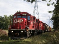 To say train movements on the Hornby- Hydro spur are rare would be an understatement, although for a short period it was often used for car storage, including in needed Expressway flat car sets. As far as actual transformer moves, maybe one every decant so. It’s funny how the entire almost 10 years that I lived in my first house just off 9th line I managed to miss 2 such moves. This I believe was the last train so far to run on the line and I only managing to catch the empty return trip. Luck was on my side this day as I was outside with my real estate agent taking photos of my house going up for sale and heard a horn where I had never heard one before. Knowing the empty cars were  sitting at the hydro facility for over a week it had to be the power coming to pick them up. In this shot the two GP38’s have two covered hoppers used as buffers, a van and the empty transformer car in tow as they slowly roll along the weed chocked spur and head back to the main. The train is about to cross Britannia Road. Today the spur remains but has been unused for anything since this photo was taken.