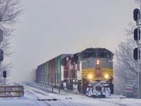 A Late CP 253 is approaching the end of its journey as it enters the island of Montreal on this cold morning. The original crew ran out of hours and had to be took over by a St-Luc crew. The fog seen in the back is covering the St-Lawrence river.