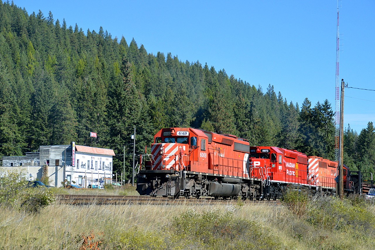 Motoring along thru the hamlet of Yahk, BC, it was nice to come across a CP rail train. And for me, seeing anything in sunshine seems to be a bonus. Nice trio of SD40-2s: CP 6069, 5973 and 5766. Found it interesting that the middle unit, #5973, not only looks spiffy in a brand new paint job, it also still sports the Golden Rodent, which I thought CP figured to be a 'waste of money' these days.
I chose this image out of a few I shot because of the "Saloon" in the background.  As for looking for a place to stay, no thank you, I'll pass. :o)