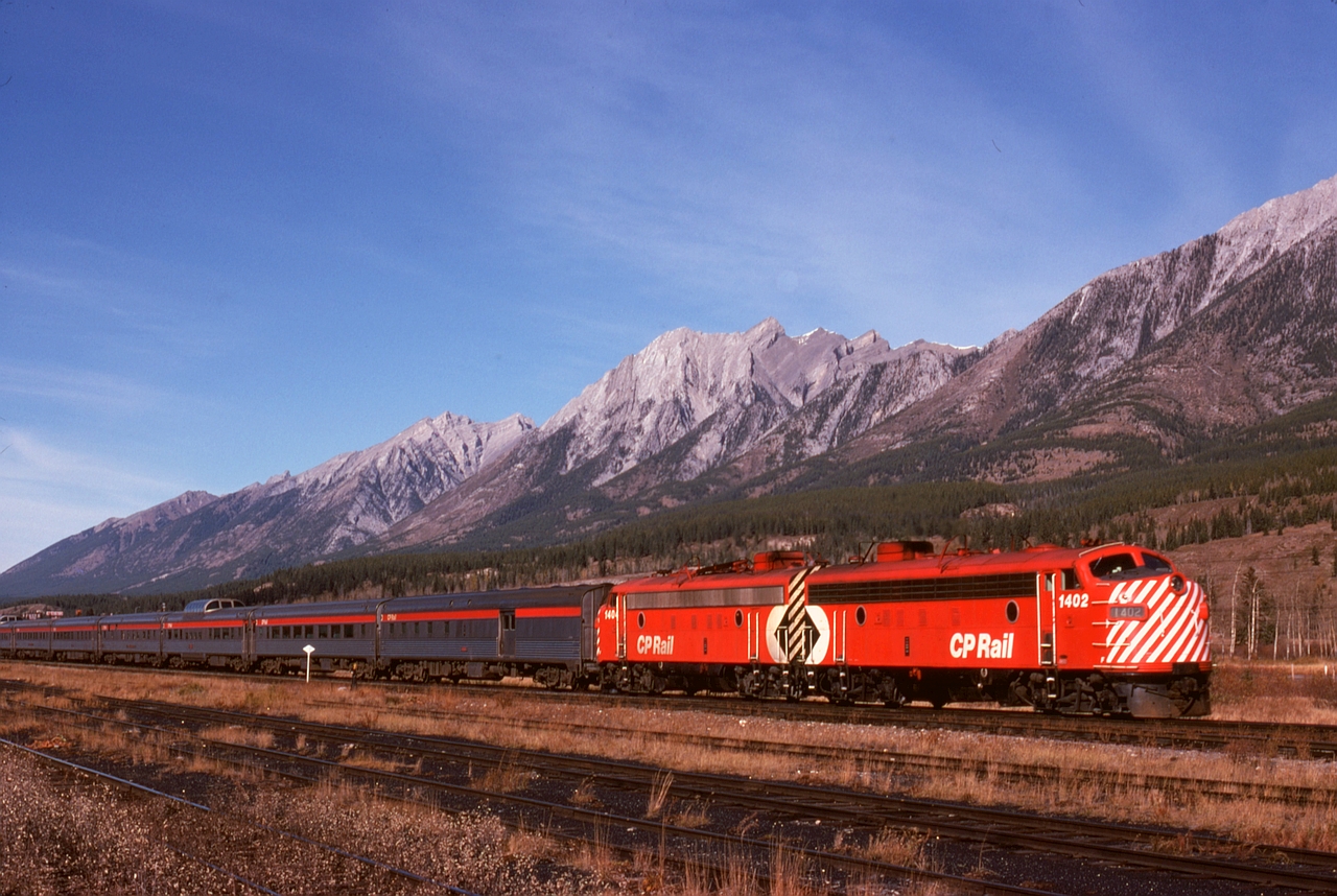 Once a simple and reliable daily sight, but now history for many years, No. 2 The Canadian is seen here on Monday 1974-10-14 at 1410 MDT departing Canmore with a typical all-stainless consist led by 1402 and 1404.