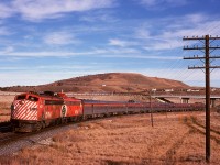 Last week, a shot of No. 2 at Canmore was shared.  Taken just 105 minutes later and 43.2 miles eastward, here is No. 1 on the same day with 1432 and 1411 handling seven cars having just passed under highway 22 Cowboy Trail at Cochrane, just 24 miles after leaving Calgary.