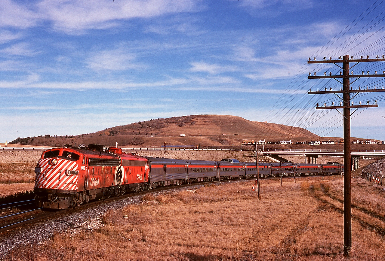 Last week, a shot of No. 2 at Canmore was shared.  Taken just 105 minutes later and 43.2 miles eastward, here is No. 1 on the same day with 1432 and 1411 handling seven cars having just passed under highway 22 Cowboy Trail at Cochrane, just 24 miles after leaving Calgary.