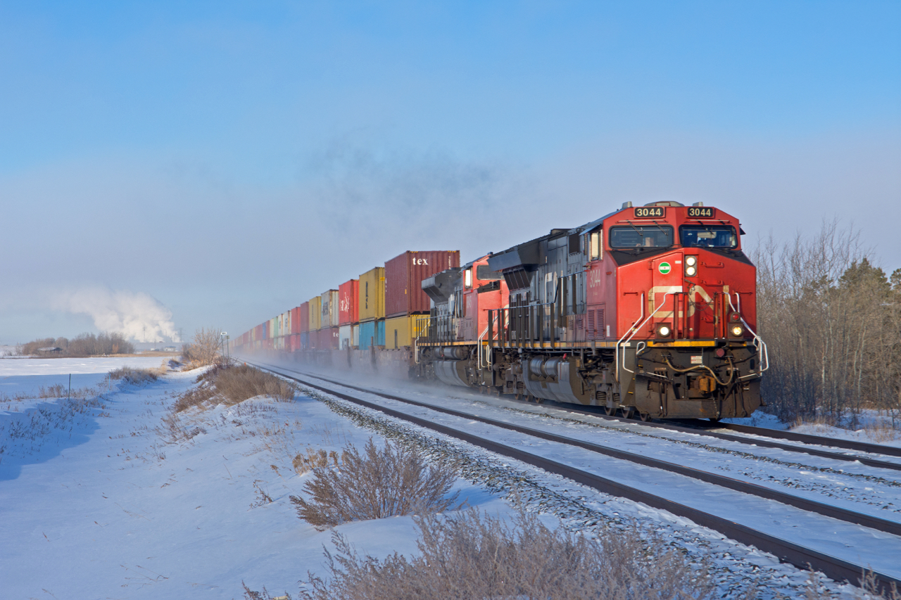 CN 196 has a fresh crew aboard and is just leaving the outskirts of Saskatoon. -42C temperatures and little to no wind made for some interesting lighting conditions as any moisture in the air would simply linger.