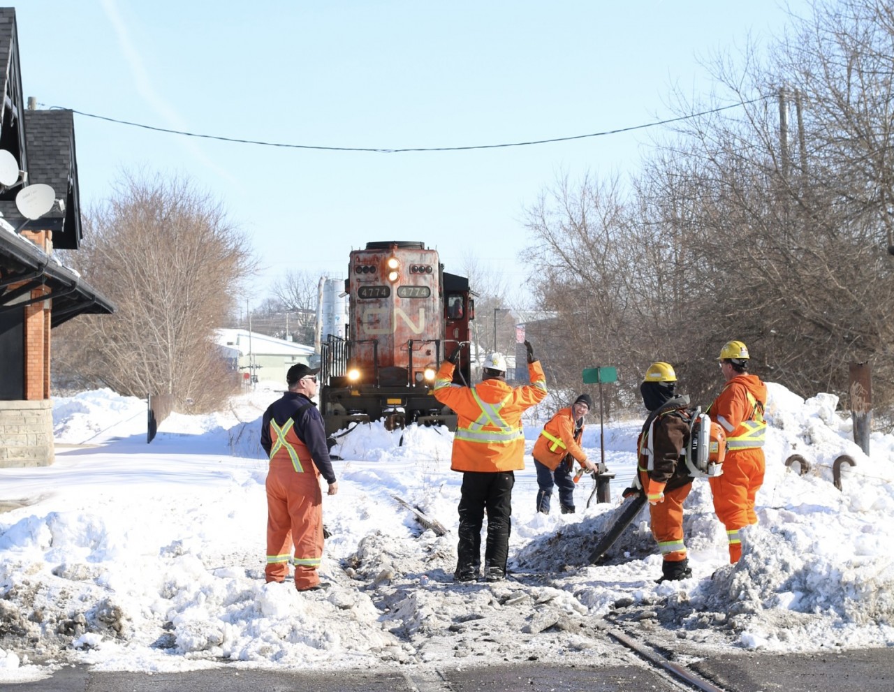 A little winter humour. The clean up crew are making the most of a frustrating day so far after being called out to clear the filled in crossing and switch in front of the old TH&B station in Brantford. The line beyond here was taken out of service when CN convinced the last on line customer to switch to trucks. This day 580 was forced to run around its train here thanks to problems with the switch at the other end of the line. This was most likely the last time a train passed here before this end of the line was abandoned. Today sadly only the old boarded up station remains and another section of interesting rails are gone from Brantford.