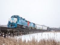 CN L518 backs up towards Invista, as they cross a little wooden trestle going across the Little Cataraqui Creek, in Kingston ON. Up front is GMTX 2254, & a surprise visitor (GTW 6224). Apparently the heater on the GTW wasn’t working, so the whole time the GMTX had to lead per crew preference, so when the GMTX came in leading eastward, heading westward they wyed the train at the Kimco Wye at Queens.