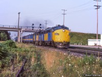 Ducking beneath Waterdown Road, VIA 73 heads west behind cab units from both GMD and MLW.  The FP9A 6532, built as <a href=http://www.railpictures.ca/?attachment_id=18552>CN 6532</a> in May 1957, would be <a href=http://www.railpictures.ca/?attachment_id=11991>rebuilt/numbered to FP9Au VIA 6310</a> in 1984.  This unit was one of the few <a href=http://www.railpictures.ca/?attachment_id=7028>repainted to the grey and yellow</a> experimental scheme in 1980.  It would be wrecked on April 9, 1993 at Rapide-Blanc, Quebec after hitting a washout.  Trailing unit FPA-4 6782, built <a href=http://www.railpictures.ca/?attachment_id=36794>for CN in March 1959</a> and retired from VIA during the late 80s.