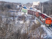 Seen looking east from the Lemonville Road bridge, CN 333 pulls back onto the main after working in Aldershot Yard.  In the consist today is CN 9657 and 9653 bracketing a pair of EMDX GP40-3 lease locomotives, 200, 201.  Both are former GO Transit GP40-2s, numbered <a href=http://www.railpictures.ca/?attachment_id=14341>GO 725</a> and GO 726, originally straight GP40s built for the Rock Island Railroad.<br><br>Shot by multiple photographers, some other views of this train:<br>Before departure from Mac Yard, <a href=http://www.railpictures.ca/?attachment_id=43475>by David Parker</a><br>Working Aldershot Yard, <a href=http://www.railpictures.ca/?attachment_id=43744>by Reg Button</a><br><br><i>Karl Bury Photo, Jacob Patterson Collection Slide.</i>