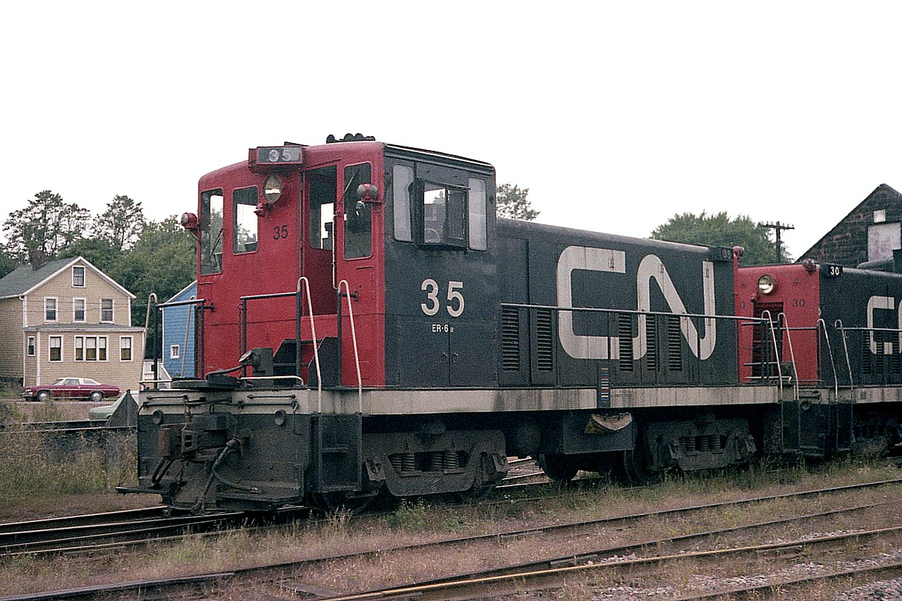 Do not recall if I ever posted a photo of CN 70-tonner #35 before.  Anyway, here it is, sitting out back of the diesel shop (along with #30) in Charlottetown PEI on a rather dull afternoon. This and the rest (4?) of the 70 tonners left on the Island in 1977 were gone by late 1983. No idea where #35 ended up. Perhaps the scrapper?
In the fall of 1977 I recall #'s 30, 35, 40 and 41 were still toiling for CN, but never did see 41. It might have departed by then. Rails have been silent on PEI since 1989. What a shame.