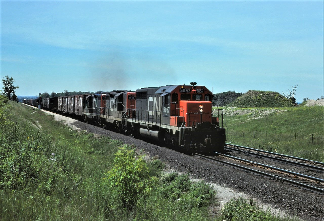 Back in the early 1970s, scenes like this were common on CN.  Older units paired with newer SD40s or C630s. Power for this train is SD40 5057 and GP9s 4516 and 4537 as it approaches Toronto Yard on the Halton Sub.