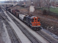 With class unit 7000 on the point, a yard assignment moves along the North Track of the Grimsby sub headed into "the hole" to serve industrial customers. At the time, most yard engines in Hamilton were MLW S4s supplemented by a couple of GM units assigned to "out posts" such as Brantford and Oakville. By the mid-1980s, SW9 and SW1200 locomotives would hold down most assignments (and SW1200RS units into the mid-1990s).