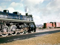 Canadian National U2g "Northern" 6219 sits by the station at Niagara Falls, likely on a westbound passenger train from Toronto, as Lehigh Valley SW900 120 leads a cross-border transfer from the US into Canada. The unit has just crossed the Niagara Whirlpool bridge and is bound for CN's Niagara Falls Yard nearby to interchange traffic.<br><br>CN 6219 was a U2g-class Northern built by MLW in 1942, and ran out of Toronto area in the 1950's until retirement. It was scrapped in April 1960.<br><br>LV 120 was originally built as an EMD NW1 in 1937, but rebuilt by EMD in 1955 as an SW900. It lasted into the early Conrail era as CR 8647.<br><br><i>Original photographer unknown (duplicate?), Dan Dell'Unto collection slide.</i>