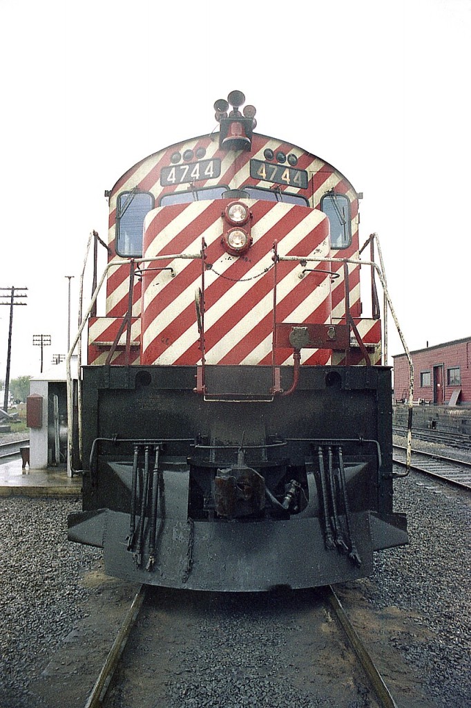 If there is a crummy day, I'll find it.  Here I am out wandering a CP yard when one was still able to do so; and of course it is pouring rain.  Grabbed a shot of CP 4744, that one-of-a-kind, model M-640. Going thru old photos here the other day and noted this shot features that earlier striped scheme on the cab end. My 3/4 shot from back then was ruined due to a lot of water on the lens, so this had to make do.
Currently the unit resides at the Canadian Railway Museum, having been donated in July 1998, after being retired 30 years ago come this April. Locomotive was built in 1971.