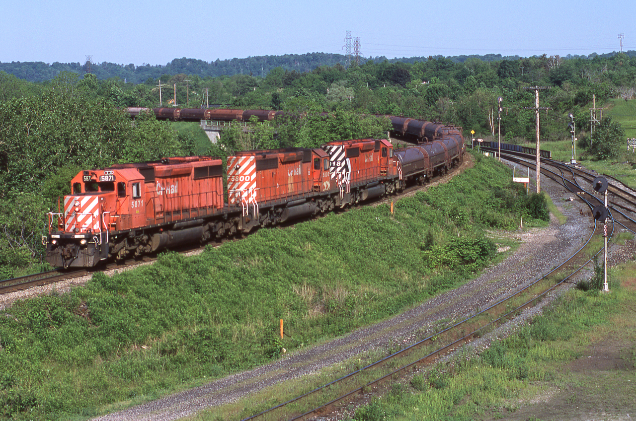 CP 222 is seen dropping down the Hamilton Sub at CN's Hamilton West on sunny June morning with it's usual trio of SD40-2s. 5871, 5800 and 6018 for the record. Akeen eye may also notice that something is lined for the "cowpath", a good sight that 328 was near.