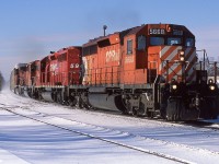 Nineteen years ago at Guelph Jct, CP 5668 East kicks up the snow with 138's train. 5668 was traded to NRE in 2005. 