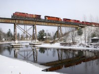 CP 251 is partly reflected in the water as it crosses the Eastman trestle with CP 9809, CP 6013, CP 7049 & CP 2266 for power.