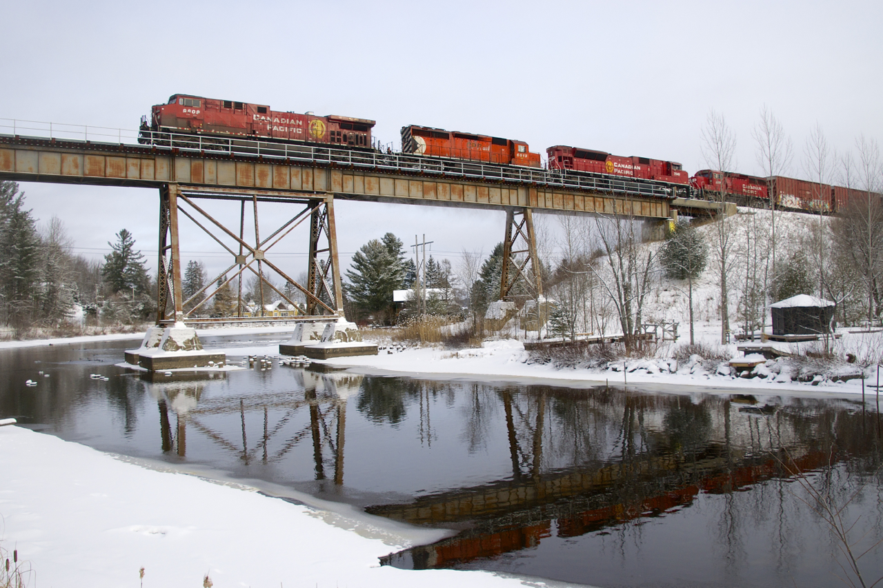 CP 251 is partly reflected in the water as it crosses the Eastman trestle with CP 9809, CP 6013, CP 7049 & CP 2266 for power.
