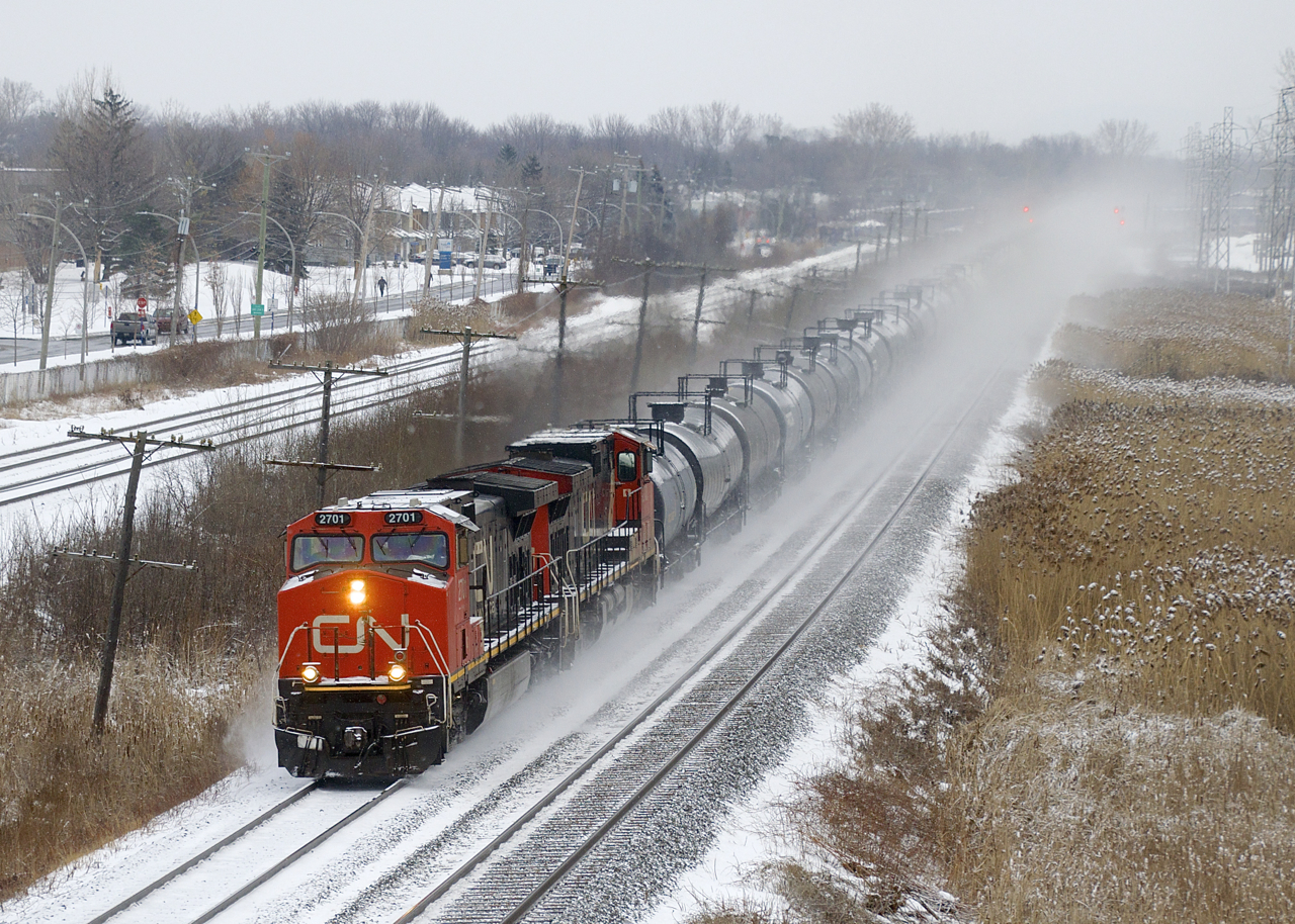 CN 377 has a pair of IC Dash9's (IC 2701 & IC 2700) as it kicks up the snow near MP 14 of CN's Kingston Sub.