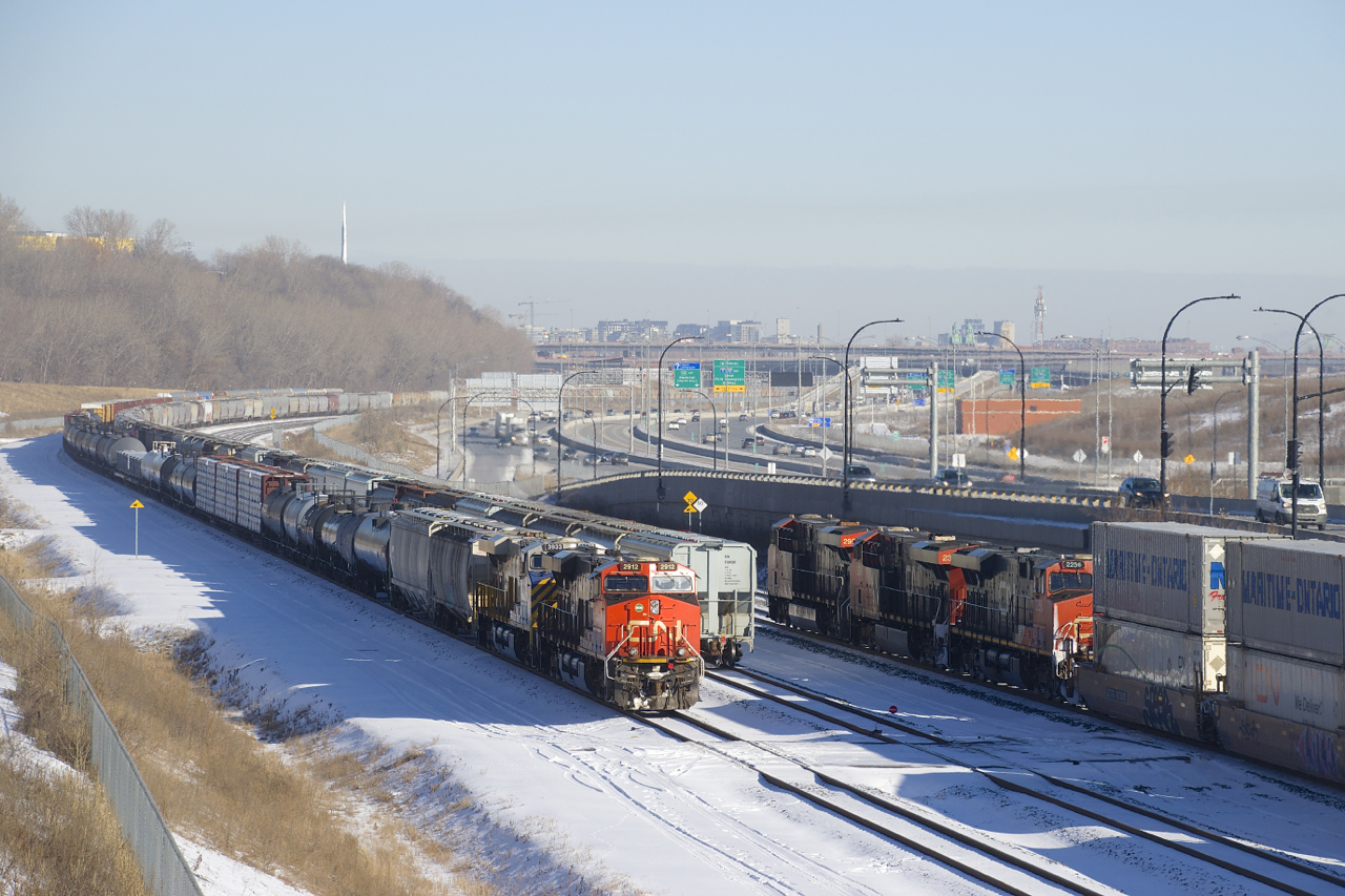 CN 120 is passing a CN 305 which is temporarily tied down on Track 29 of CN's Montreal Sub.
