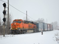 BNSF GE ES44C4 #6727 leads CN L523 solo through CN Clifton, coming off the Grimsby Sub and onto the Stamford Sub during heavy snowfall in Niagara Falls, Ontario.