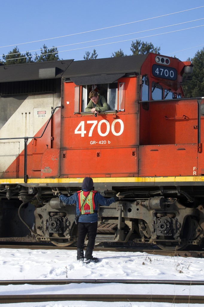 The engineer and brakeman discuss their next moves as CN 538 does quite a bit of switching on two tracks that serve the National Silicates plant. National Silicates and Goodyear are two busy clients served by CN on the Canadian Industries Limited Spur, which branches off of the Valleyfield Sub at MP 41.2.