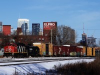 The St-Hyacinthe Switcher (CN 519) is unusually seen in Montreal, passing the skyline of the city with CN 9454 and about 60 cars to leave on Track 29 of the Montreal Sub.