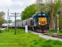 Exiting Wallaceburg, the crew of D924 is southbound passing the northbound approach for the swing bridge located at the North Siding Switch Wallaceburg. This days consist is made up of hoppers for Tupperville and 3 tanks for Sombra. But due to north facing switches requires the crew to traverse the extent of the (then in service portion of the) Sarnia Sub to Dresden to run around their train before working the industries on their return trip. 