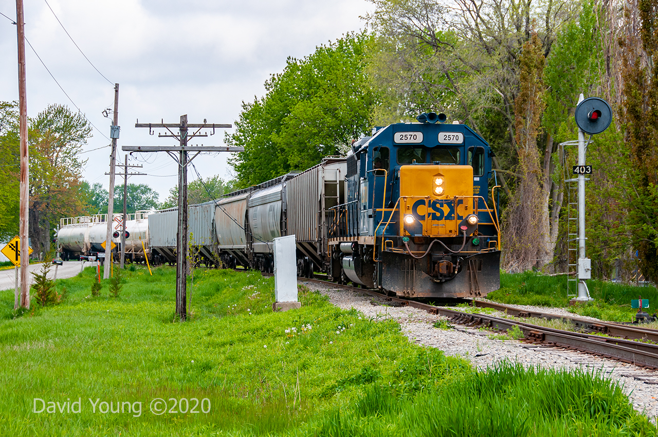 Exiting Wallaceburg, the crew of D924 is southbound passing the northbound approach for the swing bridge located at the North Siding Switch Wallaceburg. This days consist is made up of hoppers for Tupperville and 3 tanks for Sombra. But due to north facing switches requires the crew to traverse the extent of the (then in service portion of the) Sarnia Sub to Dresden to run around their train before working the industries on their return trip.