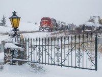 CN L542 pauses on the Fergus Spur just outside FloChem while the conductor and trainee meet with the yard foreman to discuss spotting the inbound cars.  Their 15 minute break allowed plenty of time for a farmer to finish plowing his driveway which crosses both the Fergus Spur main track and the FloChem siding.  Shortly, 4732 will cut off from it's train and run ahead to the switch for the crew to sweep it out and start their work.