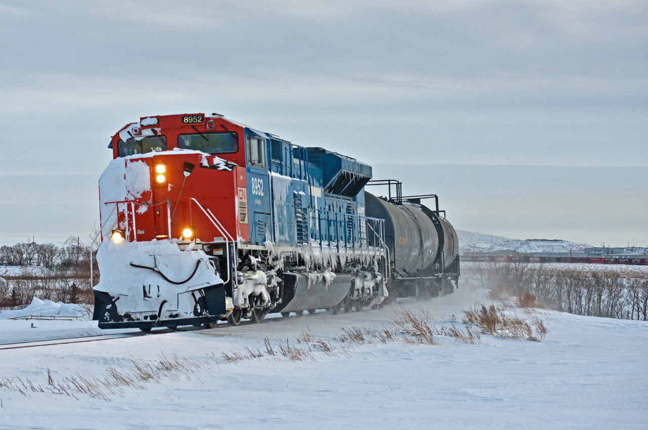 A snow caked CN 8952 leads an X405 north out of Regina on the Quappelle Subdivision at Victoria Plains.