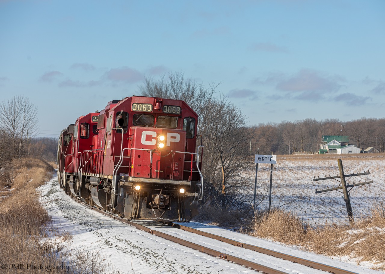 CP T08 crawls up the curved grade past station sign Myrtle, as they are slowly making their way east towards Havelock on the very scenic Havelock Sub. This train has a unique GP38-2 in the lead, which is not so common for the Havelock runs to have considering it’s often ECO’s leading for the most part.