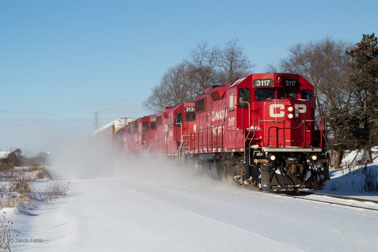 CP T72 kicks up snow as it flies East approaching Ayr, Ontario.