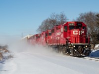 CP T72 kicks up snow as it flies East approaching Ayr, Ontario.