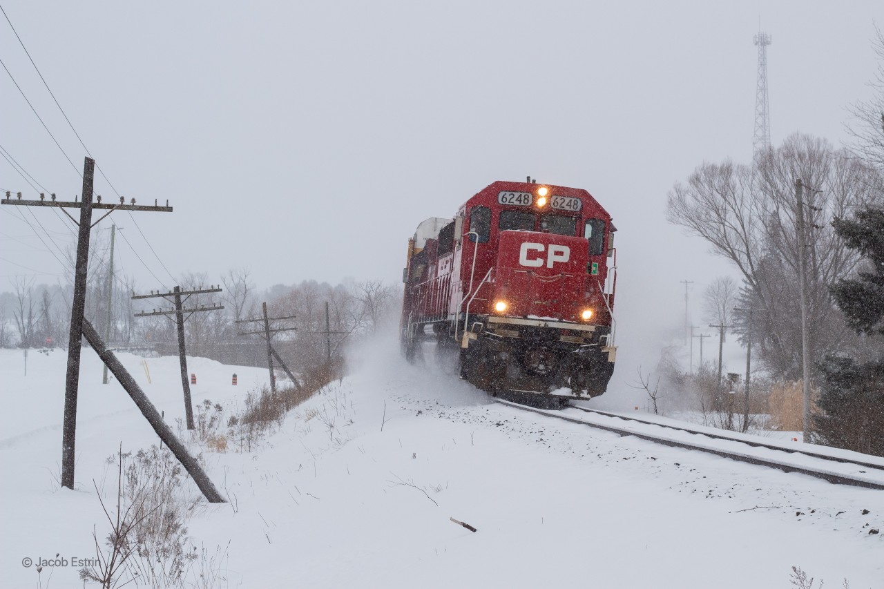 T78 kicks up the fresh powered snow as it flies West on the Galt through Innerkip, Ontario on the approach to Pender.