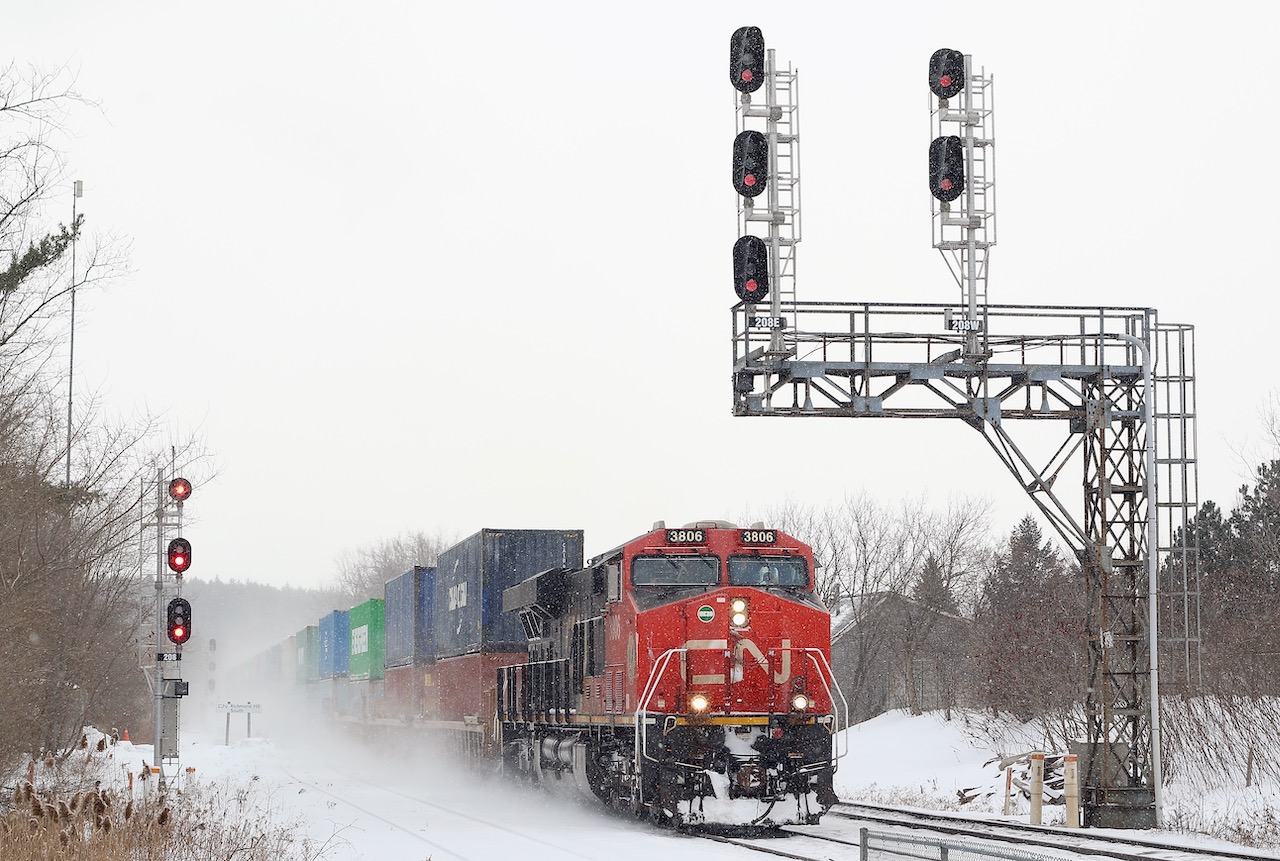 I rarely make it over to the Bala sub. but a PD day for my boys made us try something different. The day for the most part was a wash with next to no trains and bad weather quickly rolling in, but at least I was able to try this angle at Richmond Hill South that would definitely not work on a sunny day. It is nice to see some of these old signal bridges still surviving even if the signals have been replaced. Here CN 101 has just met a southbound and is digging into the grades the snowfall gets heavier. The trains seen passing the GO station with another GE pushing hard on the tail end.