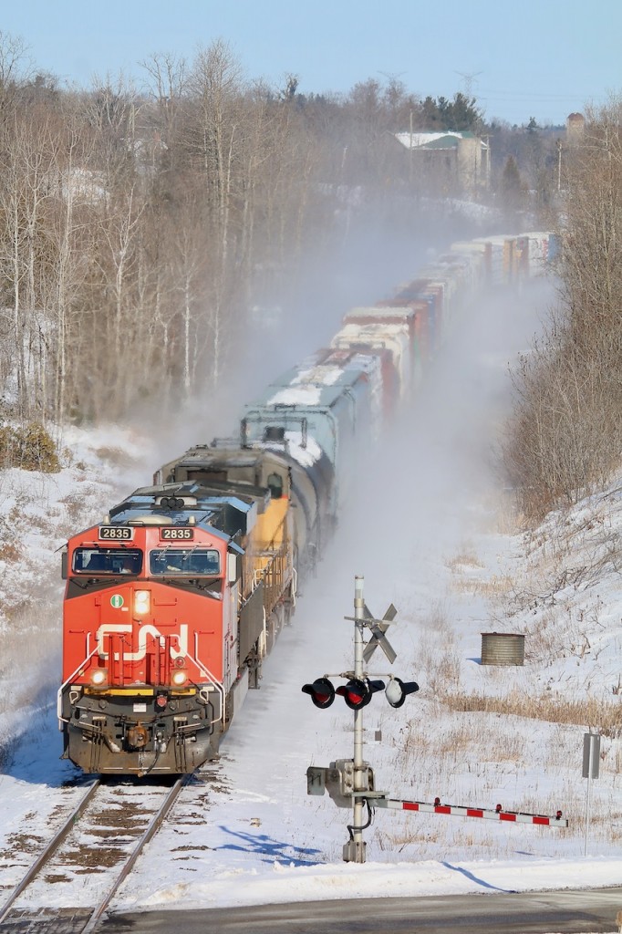 I really wasn't planning on a nice bitterly cold hike this morning, but a very slow 397 and time to kill changed that. I have always loved the view from the golf course bridge at mile 30 but it has been ages since I've done the shot. I was glad to see the sun appear even if it didn't warm up things. Hearing CN 397 had a UP trailing made it worth the effort this morning.
