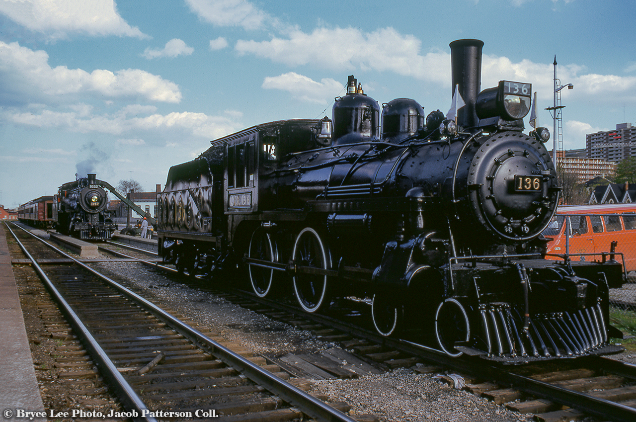 Former Canadian Pacific Railway steam locomotives 136 and 1057, now in excursion service lettered for the Credit Valley Railway, are seen outside the TH&B station at Hamilton.  Earlier in the day they had run an excursion from Toronto - Guelph Junction - Hamilton, and are taking on coal before their return trip.Bryce Lee Photo, Jacob Patterson Collection Slide.