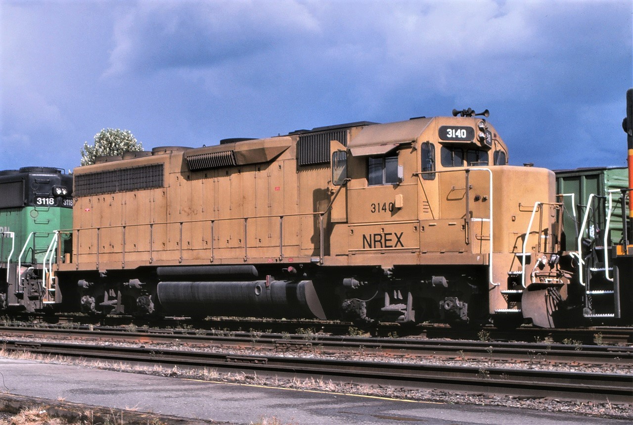 NREX GP40 3140 caught in front of the BNSF station in New Westminster BC in August 1998.  The unit began life in August 1968 as PC 3128.  It went to Conrail as their 3128, then to D&RGW as 3140 and then to NREX 3140.  It finally was sold to Rock and Rail as their 401.