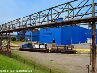 Enemy Territory: A Dofasco locomotive in Stelco territory? Yes, it happened! Known to be bitter rivals in the Steel Industry in Hamilton, probably unheard of to see a Stelco Locomotive in Dofasco or vice versa. After some kind of incident crushed the cab of 416, it was sent to nearby Railcare for work. After being lifted from <a href=http://www.railpictures.ca/?attachment_id=40853 target=_blank>Dofasco Bayfront (The last such move that I am aware of from here to date)</a> the crew had to go into Stelco to lift a gaggle of loaded coil cars, light power. Leading the movement is Dofasco 416 well inside the Unionized Stelco facility. After lifting Stelco, the crew then ran light power into Railcare to deposit the locomotive. A wise choice of moves that made this photograph possible.