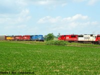 I posted this <a href=http://www.railpictures.ca/?attachment_id=41918 target=_blank>meeting of four different CP SD70ACu paint schemes at Wolverton from 2020</a> and here's a different kind of meet - in 2005 I got to Wolverton just in time for an Intermodal to meet an eastbound manifest. Pairs of soo painted units were common, and junk leasers were on many trains including the train in the siding. Lots to stare at, and this was well before any activity happened to build the yard now located here. If anyone can fill in the symbols it's appreciated :)