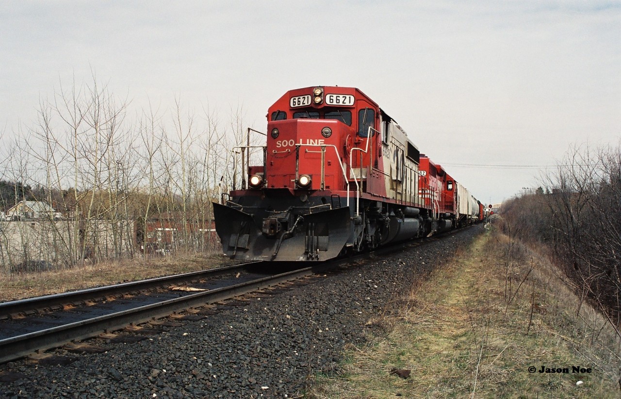 With a friendly wave from the conductor, a CP westbound is slowly passing the west siding switch at Killean, Ontario with work ahead in Galt. Here SOO Line SD40-2 6621 and SD40 6402 will left two hot cars at the Galt yard from Butler Metals in Cambridge before continuing their trip to London over the Galt Subdivision.