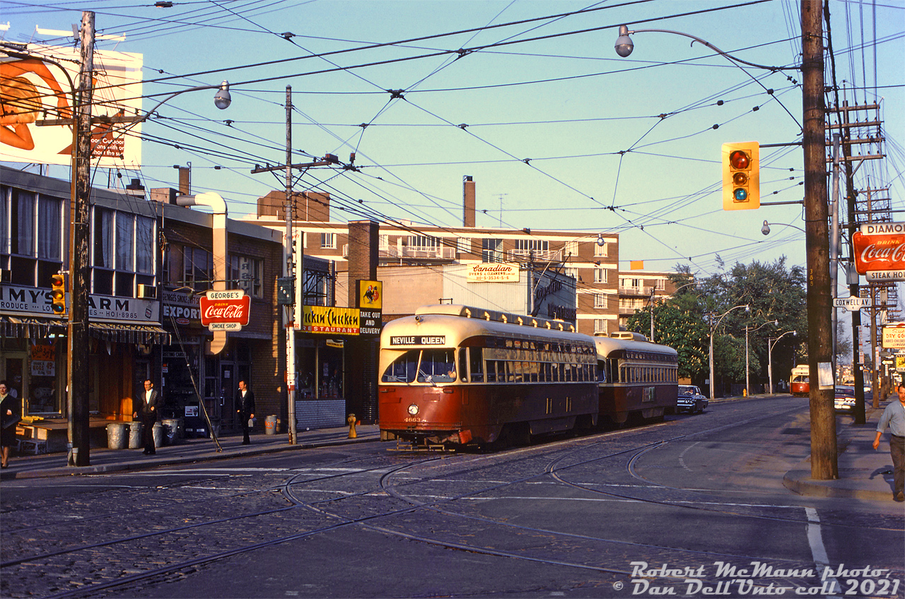 Morning in the Leslieville neighbourhood: residents head off to work, some with lunch boxes in hand, as a pair of MU'ed TTC PCC streetcars pause at the light eastbound on Queen at Coxwell. The lead car is TTC 4663 (A11-class, originally built 1946 for Cleveland), with a TTC 4400-series car (A7-class, new to the TTC in 1949) coupled behind. Both classes were equipped with couplers for MU service, originally for the busy Bloor streetcar route, and later migrating to service on Queen. In the distance, another two eastbound PCC cars approach.

Today, most of the low-rise storefront and apartment buildings here still remain, although the customers have changed. Stores visible in 1968 are: Jimmy's Farm (produce), George's Smoke Shop (variety), Pickin' Chicken Restaurant, Canadian Dyers & Cleaners. On the right are signs for Diamond Steak House, and Sue's Dry Goods (clothing).

Robert D. McMann photo, Dan Dell'Unto collection slide.