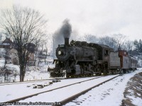 Long before becoming <a href=http://www.railpictures.ca/?attachment_id=19070>a well known excursion locomotive,</a> CPR 1057 was just another D10h 4-6-0 working the branch lines of southern Ontario, on this day, handling mixed trains 715/716 on the Walkerton branch. Seen here on arrival from Orangeville approaching the small yard at Walkerton, 1057 will run around the consist and complete any work in town before departure back to Orangeville.<br><br>Canadian Pacific's Walkerton Subdivision originated as the Walkerton & Lucknow Railway, incorporated in 1904, construction would begin in 1906 and be fully completed in 1908, splitting off the Owen Sound Subdivision at <a href=http://www.railpictures.ca/?attachment_id=47318>Saugeen Junction</a> and running west via Durham and Hanover to it's namesake town. The CPR would lease the railway beginning November 1906, and the line would open for service in August 1908. <a href=http://www.trainweb.org/oldtimetrains/time/walkertontt1909.jpg>Per a 1909 timetable,</a> there were at one time four scheduled passenger trains over the line daily except Sunday, plus other freight movements. During the 1930s, effects of the Great Depression were felt on most branch lines and passenger services were reduced or eliminated. By 1932, the Walkerton branch passenger services were replaced with a daily except Sunday mixed train. Service on the line continued as such until August 3, 1957, when mixed trains 715/716 would be discontinued, leaving the line freight only. Mixed trains 753/756 to Teeswater also ran their last miles on this day. July 1983 saw abandonment of the Walkerton Sub from a point west of Hanover to Walkerton, with the condition that ownership and operations of industrial trackage within Hanover would be transferred to CN. By transferring service to CN, CP would be allowed to abandon the remainder of the Walkerton Sub from Saugeen to Hanover. By 1984, the Walkerton Subdivision would be abandoned, the switches at Saugeen Junction removed by October, and the entire line removed by December of that year.  *Information from a number of UCRS Newsletters.<br><br><i>Original Photographer Unknown, Jacob Patterson Collection Slide.</i>